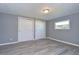 Spacious bedroom featuring gray walls, wood-look floors, and ample closet space at 39053 Flora Ave, Zephyrhills, FL 33542