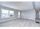 Open living room with gray walls and wood-look flooring at 39053 Flora Ave, Zephyrhills, FL 33542