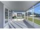 Spacious screened porch with white frame and gray flooring at 39053 Flora Ave, Zephyrhills, FL 33542