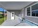 Mobile home exterior showcasing covered patio and gray siding at 39053 Flora Ave, Zephyrhills, FL 33542