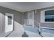 Mobile home exterior with covered patio and gray siding at 39053 Flora Ave, Zephyrhills, FL 33542
