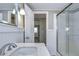 Updated bathroom with white vanity, quartz countertop, and glass shower at 39053 Flora Ave, Zephyrhills, FL 33542