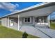 Mobile home exterior with covered carport and gray siding at 39053 Flora Ave, Zephyrhills, FL 33542
