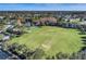 Aerial view of community showing large green space, soccer field, and basketball court at 4911 Diamonds Palm Loop, Wesley Chapel, FL 33543