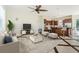 Bright living room open to the kitchen, featuring tile floors, a ceiling fan and modern furniture at 496 Palm Ave, Palm Harbor, FL 34683