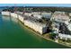 Aerial view of waterfront condo building with surrounding buildings and water at 6020 Shore S Blvd # 508, Gulfport, FL 33707