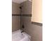 Clean bathroom with tile surround and tub shower combination at 6345 Newtown Cir # 45A3, Tampa, FL 33615