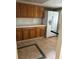 Kitchen with wood cabinets, white appliances, and granite counter at 6345 Newtown Cir # 45A3, Tampa, FL 33615