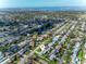 An aerial view displays the property's location near a pond, surrounded by lush greenery and residential neighborhood at 6701 13Th N Ave, St Petersburg, FL 33710