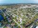 An aerial view shows the neighborhood near a lake, with houses nestled among green trees and roadways at 6701 13Th N Ave, St Petersburg, FL 33710