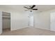This carpeted bedroom features a ceiling fan, closet, and adjacent bathroom at 6701 13Th N Ave, St Petersburg, FL 33710