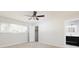 Bright bedroom with large window, ceiling fan, carpet and an ensuite bathroom at 6701 13Th N Ave, St Petersburg, FL 33710