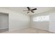 Neutral carpeted bedroom featuring a ceiling fan and a bright window providing ample natural light at 6701 13Th N Ave, St Petersburg, FL 33710