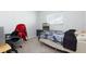 Cozy bedroom with a bed, desk, and dresser, complemented by natural light from a window at 6701 13Th N Ave, St Petersburg, FL 33710