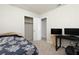 Bright bedroom featuring a bed, closet, and workspace with dual monitors at 6701 13Th N Ave, St Petersburg, FL 33710