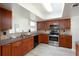 Well-lit kitchen features stainless steel appliances, granite countertops, and wood cabinets at 6701 13Th N Ave, St Petersburg, FL 33710