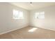 Well-lit bedroom with carpet and two windows at 6701 13Th N Ave, St Petersburg, FL 33710