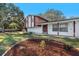 Front view of a house with red and white siding and a landscaped front yard at 7002 Lawnview Ct, Tampa, FL 33615