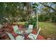 Relaxing patio with table and chairs, nestled among lush landscaping at 1003 Mandalay Dr, Brandon, FL 33511