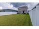 Spacious backyard with grassy lawn and white fence at 11834 Brighton Knoll Loop, Riverview, FL 33579