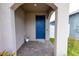 Front entrance with blue door and brick walkway at 11834 Brighton Knoll Loop, Riverview, FL 33579