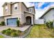 Two-story house with gray siding, blue door, and walkway at 11834 Brighton Knoll Loop, Riverview, FL 33579