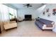 Bright living room with tiled floor, comfortable seating, and a large TV at 11834 Brighton Knoll Loop, Riverview, FL 33579