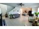 Open living room with kitchen view, tiled floor, and comfortable seating at 11834 Brighton Knoll Loop, Riverview, FL 33579