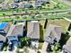 A high-angle shot showcases well-maintained homes in a desirable neighborhood, each with manicured lawns and modern architecture at 16912 Yellow Pine St, Wimauma, FL 33598