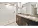 Bathroom featuring double sinks, a granite countertop, and a walk-in shower at 16912 Yellow Pine St, Wimauma, FL 33598