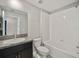 Bathroom featuring a shower-tub combo and granite countertops at 16912 Yellow Pine St, Wimauma, FL 33598