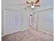 Bedroom featuring a ceiling fan and double door closet at 16912 Yellow Pine St, Wimauma, FL 33598
