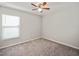 Carpeted bedroom with a ceiling fan and a window at 16912 Yellow Pine St, Wimauma, FL 33598