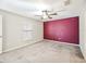Cozy bedroom with carpet flooring features a ceiling fan and natural light at 16912 Yellow Pine St, Wimauma, FL 33598