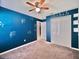 Bedroom featuring a ceiling fan, music-themed decor, and closet at 16912 Yellow Pine St, Wimauma, FL 33598