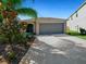 Beautiful single-story home with a well-maintained lawn and two-car garage at 16912 Yellow Pine St, Wimauma, FL 33598