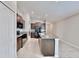 Modern kitchen with granite countertops, dark cabinetry, and stainless steel appliances at 16912 Yellow Pine St, Wimauma, FL 33598