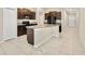 Modern kitchen boasts granite countertops, stainless steel appliances, and dark wood cabinets at 16912 Yellow Pine St, Wimauma, FL 33598