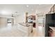 Open-concept kitchen with granite countertops, stainless steel appliances, and tile flooring at 16912 Yellow Pine St, Wimauma, FL 33598