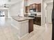 Open-concept kitchen with granite countertops and stainless steel appliances at 16912 Yellow Pine St, Wimauma, FL 33598