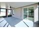 Large screened-in porch with fan and views of the landscaped backyard at 16912 Yellow Pine St, Wimauma, FL 33598