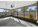 Relaxing screened-in porch provides a view of the backyard and landscaping at 16912 Yellow Pine St, Wimauma, FL 33598