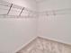 Empty walk-in closet with wire shelving and carpeted floor at 16912 Yellow Pine St, Wimauma, FL 33598