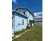 Side view of light blue house, showing yard and satellite dish at 1905 And 1907 N Armenia Ave, Tampa, FL 33607