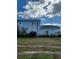 Light blue two-story house with side yard at 1905 And 1907 N Armenia Ave, Tampa, FL 33607