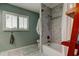 Bathroom with shower/tub combo, gray marble walls, and window shutters at 390 Cypress Creek Cir, Oldsmar, FL 34677