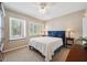 Comfortable bedroom with a white coverlet, blue headboard, and shuttered windows at 390 Cypress Creek Cir, Oldsmar, FL 34677