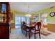 Bright dining room with wood table and chairs, and view to kitchen at 390 Cypress Creek Cir, Oldsmar, FL 34677