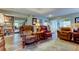 Comfortable living room with leather armchairs and bookcase at 390 Cypress Creek Cir, Oldsmar, FL 34677