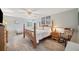 A main bedroom with a four-poster bed, ceiling fan, and light gray wood-look flooring at 390 Cypress Creek Cir, Oldsmar, FL 34677